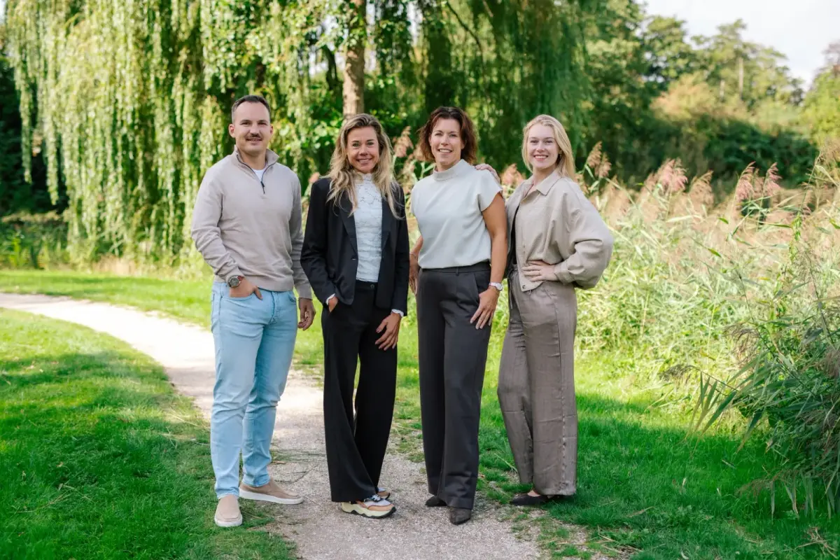 Het team van Makelaardij Germeraad buiten op een pad bij de wilgen